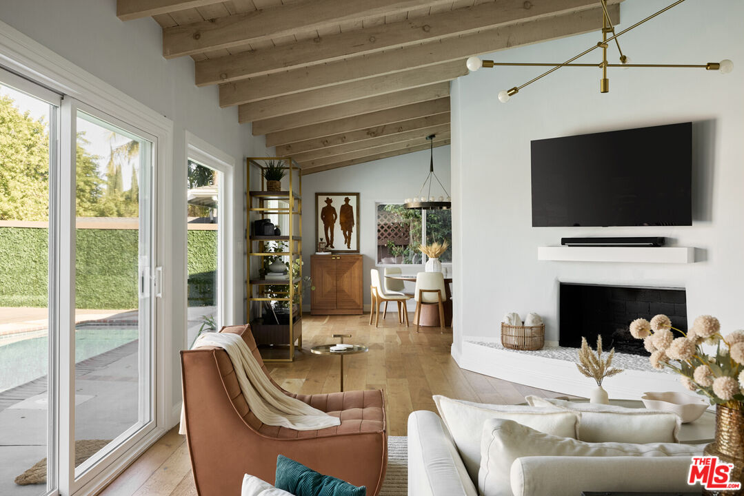 14833 Valley Vista Boulevard Sherman Oaks, CA 91403 - Photo 4 of 39 a living room with fireplace furniture and a flat screen tv