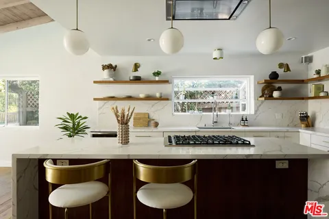 a kitchen with a table and chairs in it