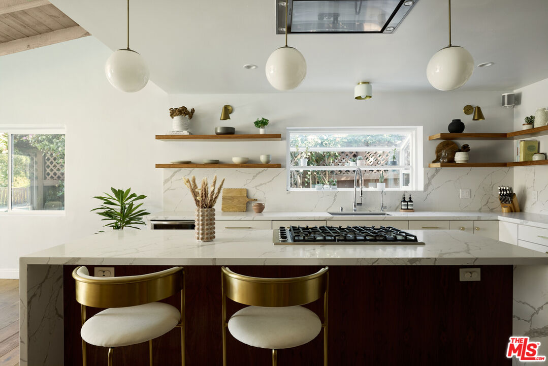 14833 Valley Vista Boulevard Sherman Oaks, CA 91403 - Photo 9 of 39 a kitchen with a table and chairs in it