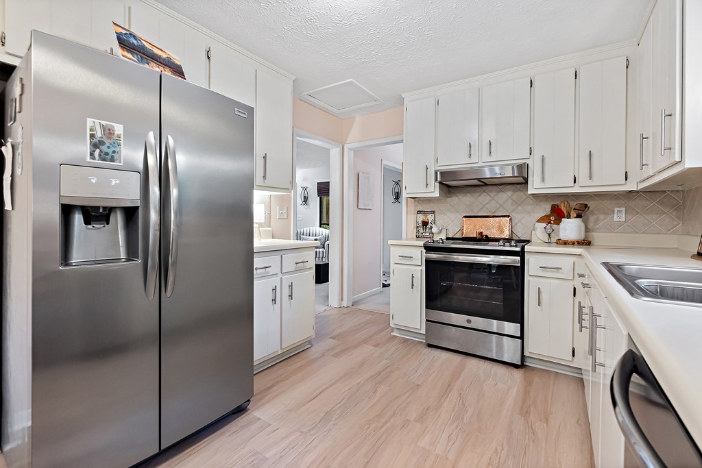 706 Magnolia Way Woodstock, GA 30188 - Photo 11 of 24 a kitchen with a refrigerator sink and cabinets