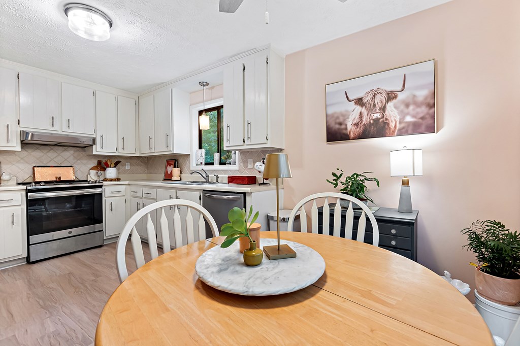706 Magnolia Way Woodstock, GA 30188 - Photo 14 of 24 a kitchen with a table chairs and a stove