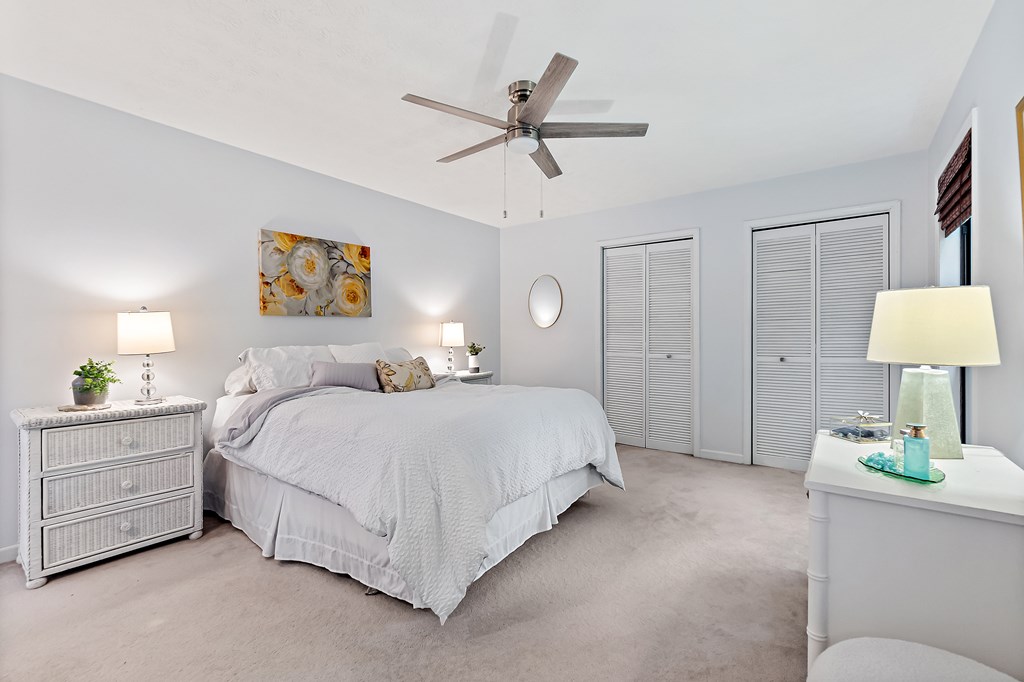 706 Magnolia Way Woodstock, GA 30188 - Photo 20 of 24 a spacious bedroom with a bed a lamp and a chandelier