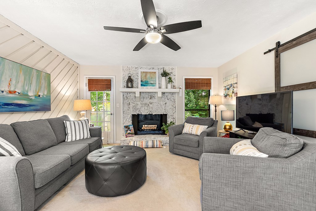 706 Magnolia Way Woodstock, GA 30188 - Photo 3 of 24 a living room with furniture a flat screen tv and a fireplace