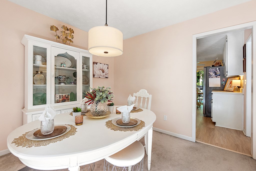 706 Magnolia Way Woodstock, GA 30188 - Photo 8 of 24 a view of a dining room with furniture a chandelier and kitchen view