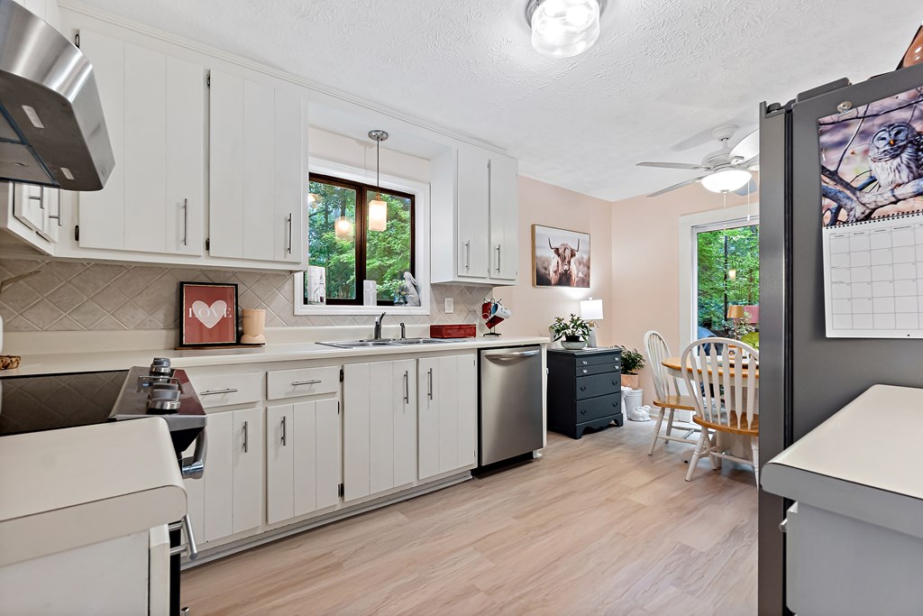 706 Magnolia Way Woodstock, GA 30188 - Photo 9 of 24 a kitchen with a refrigerator stove top oven and sink