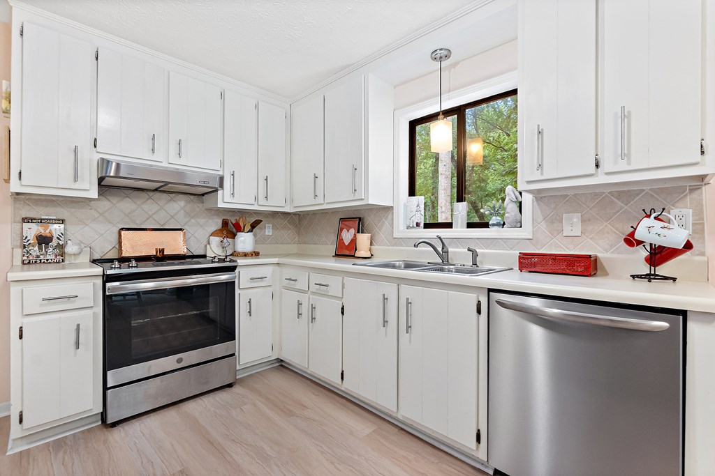 706 Magnolia Way Woodstock, GA 30188 - Photo 10 of 24 a kitchen with granite countertop white cabinets and white appliances
