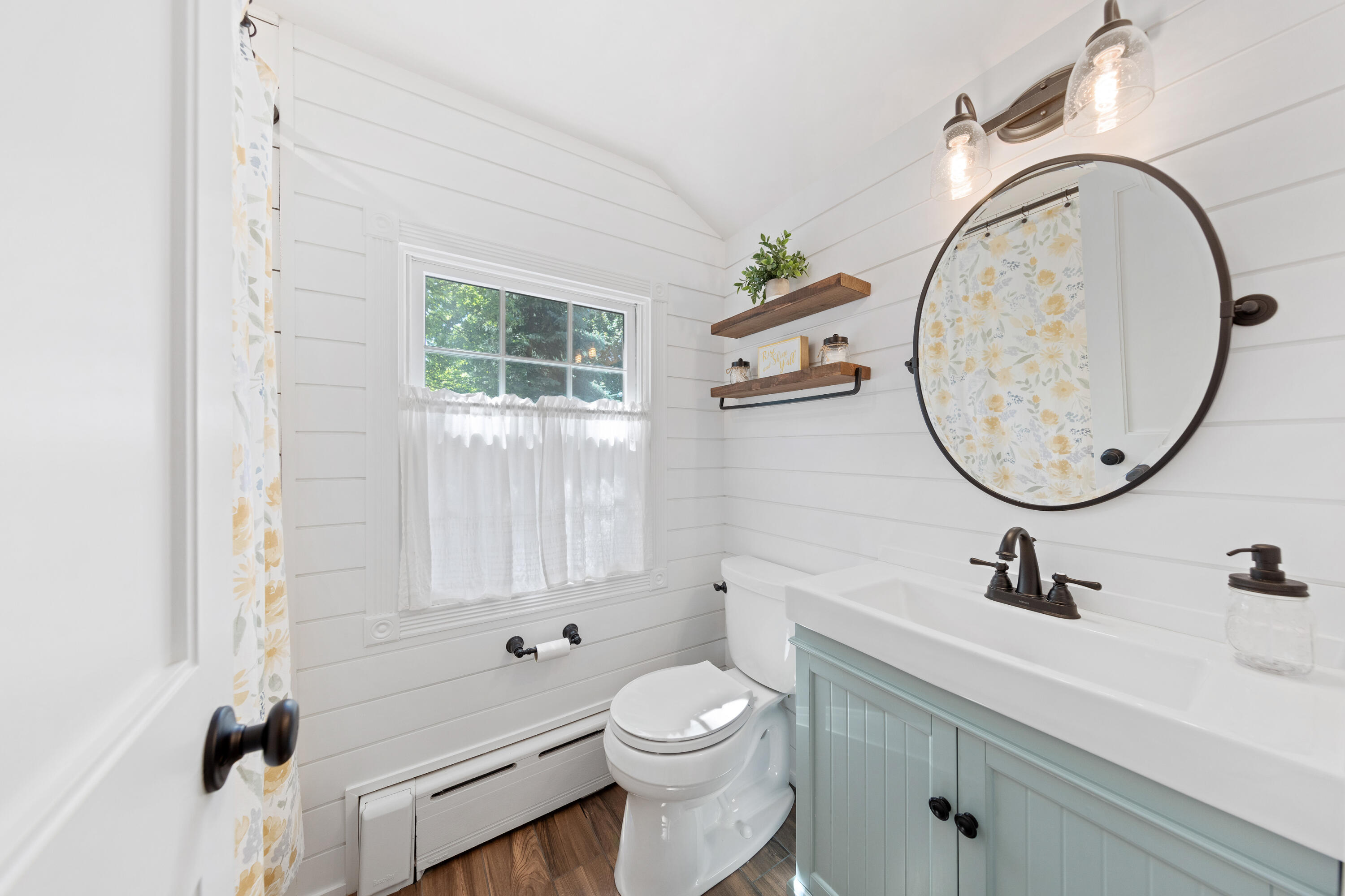 12 Miles Road Darien, CT 06820 - Photo 22 of 31 a bathroom with a sink a toilet and a mirror