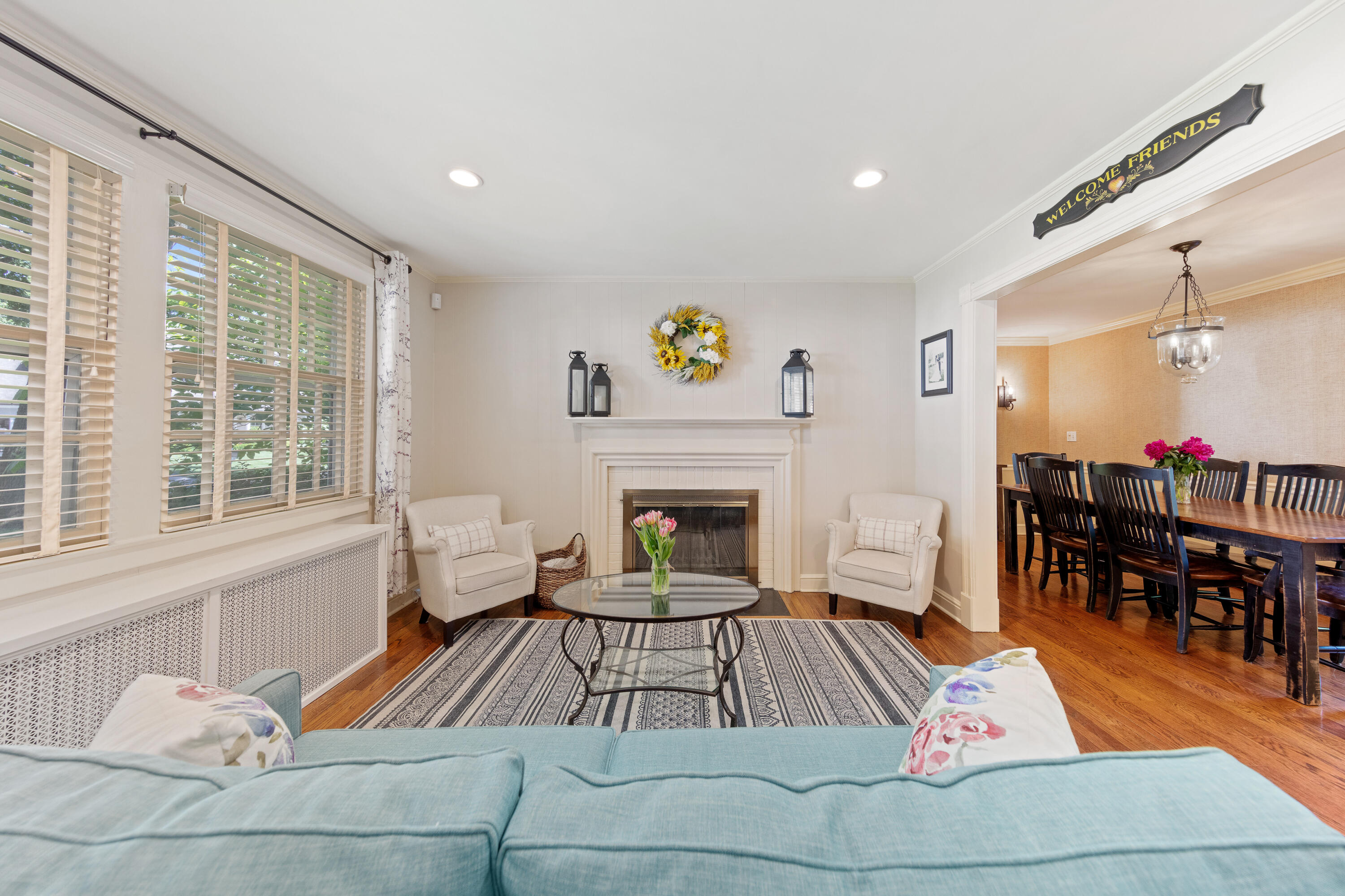 12 Miles Road Darien, CT 06820 - Photo 4 of 31 a living room with furniture a dining table and a fireplace with wooden floor