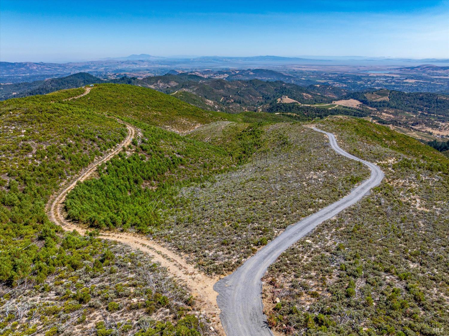 4420 Cavedale Road Sonoma, CA 95476 - Photo 3 of 25 Road to the right takes you the the building envelope while the dirt road takes you to the Napa County boundary on the East side of the property.