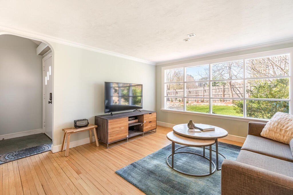 382 Worcester Street Wellesley, MA 02481 - Photo 1 of 22 a living room with furniture a rug and a window