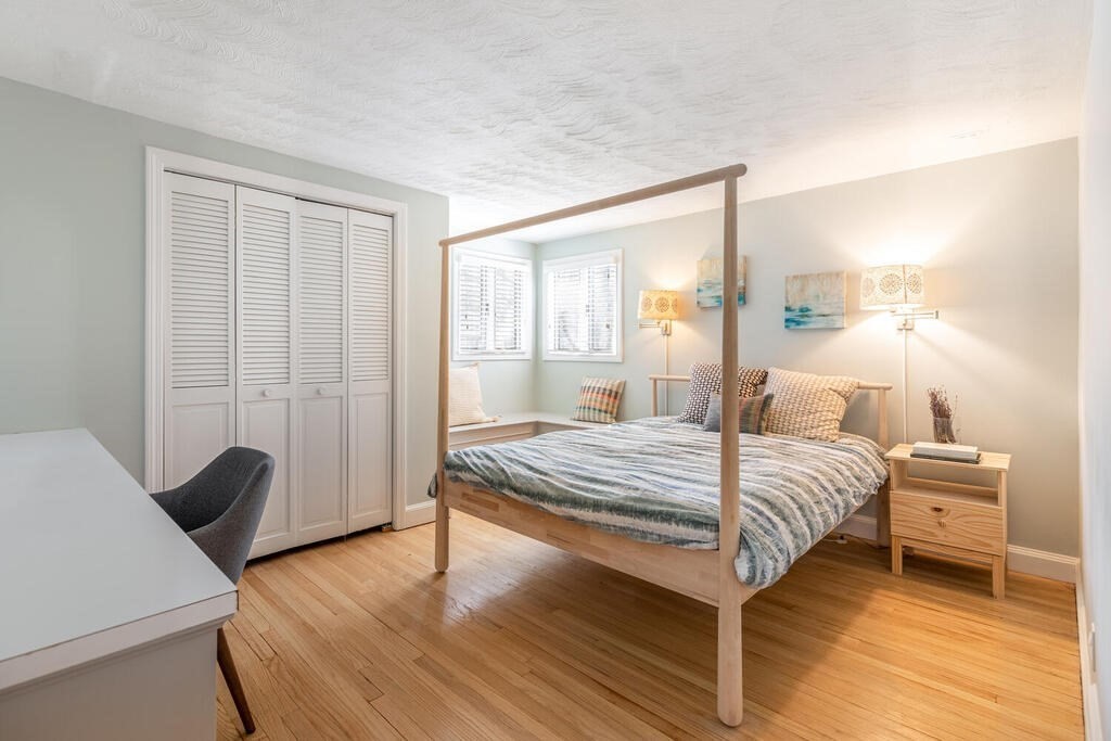 382 Worcester Street Wellesley, MA 02481 - Photo 13 of 22 a bedroom with a bed and wooden floor