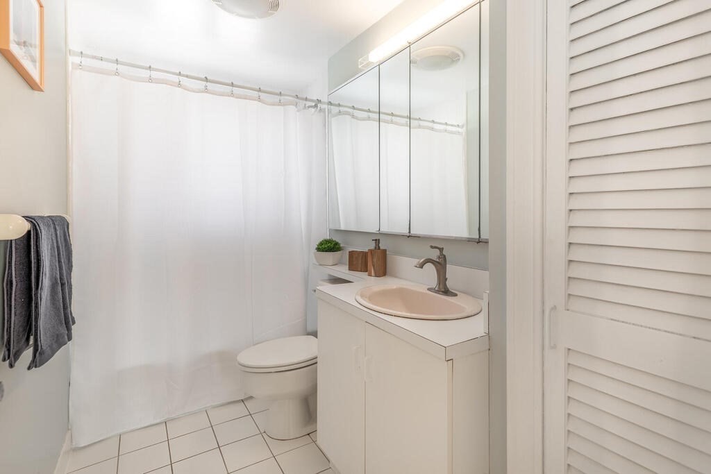 382 Worcester Street Wellesley, MA 02481 - Photo 15 of 22 a bathroom with a sink a toilet and a mirror