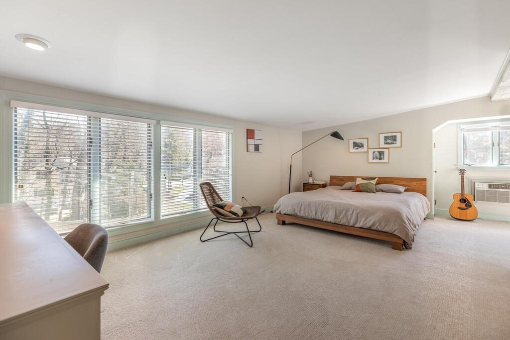 382 Worcester Street Wellesley, MA 02481 - Photo 16 of 22 a spacious bedroom with a bed and a large window