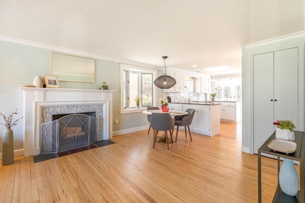 382 Worcester Street Wellesley, MA 02481 - Photo 2 of 22 a living room with a fireplace dining table and a fireplace