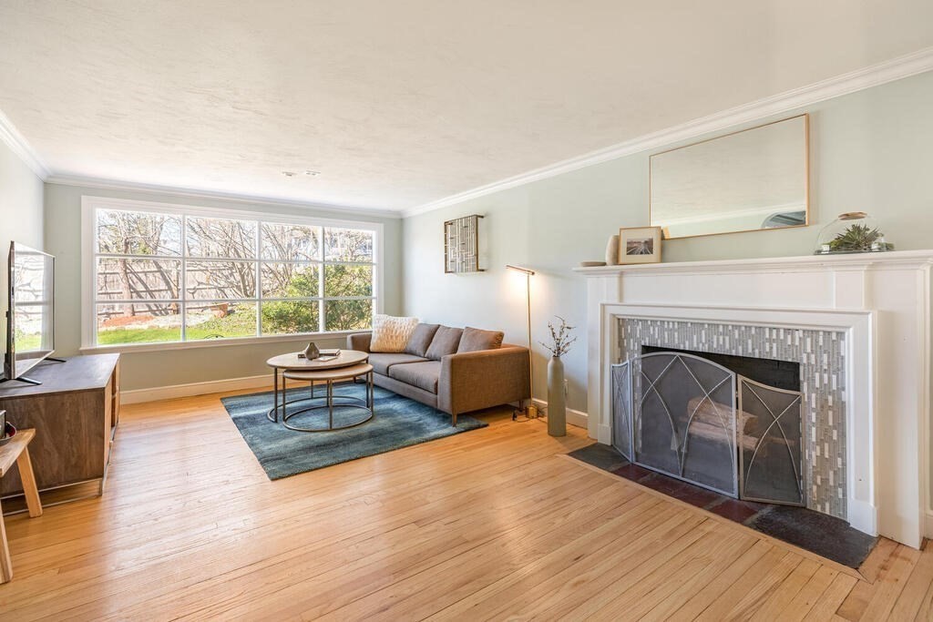 382 Worcester Street Wellesley, MA 02481 - Photo 3 of 22 a living room with furniture and a fireplace