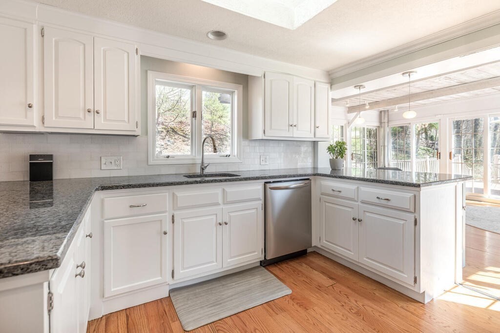 382 Worcester Street Wellesley, MA 02481 - Photo 6 of 22 a kitchen with granite countertop white cabinets and white appliances