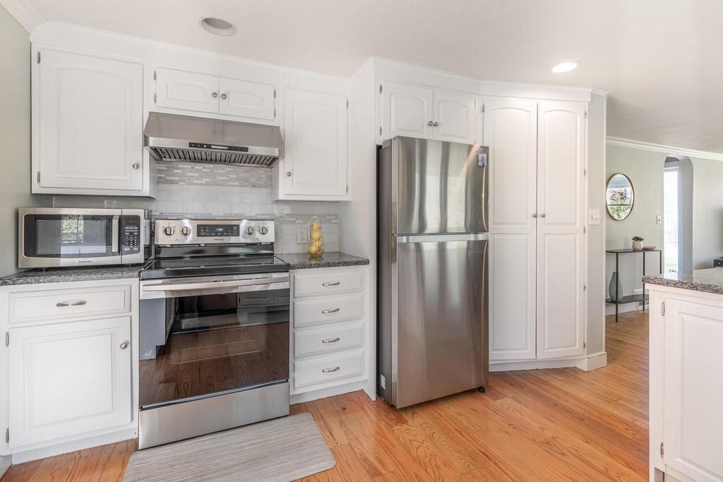 382 Worcester Street Wellesley, MA 02481 - Photo 8 of 22 a kitchen with stainless steel appliances a refrigerator stove and cabinets