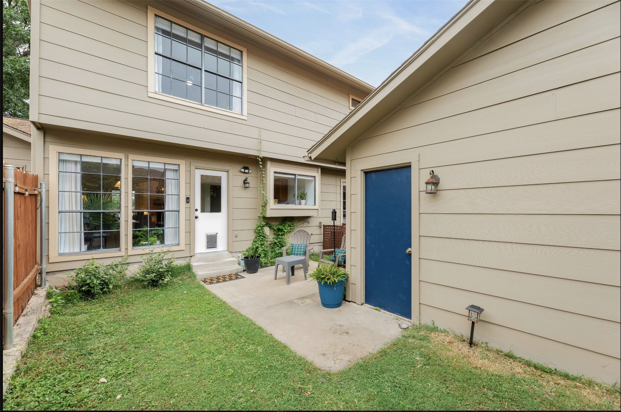 8925 North Plaza, Unit 69 Austin, TX 78753 - Photo 24 of 29 Entrance to property with a patio and a lawn