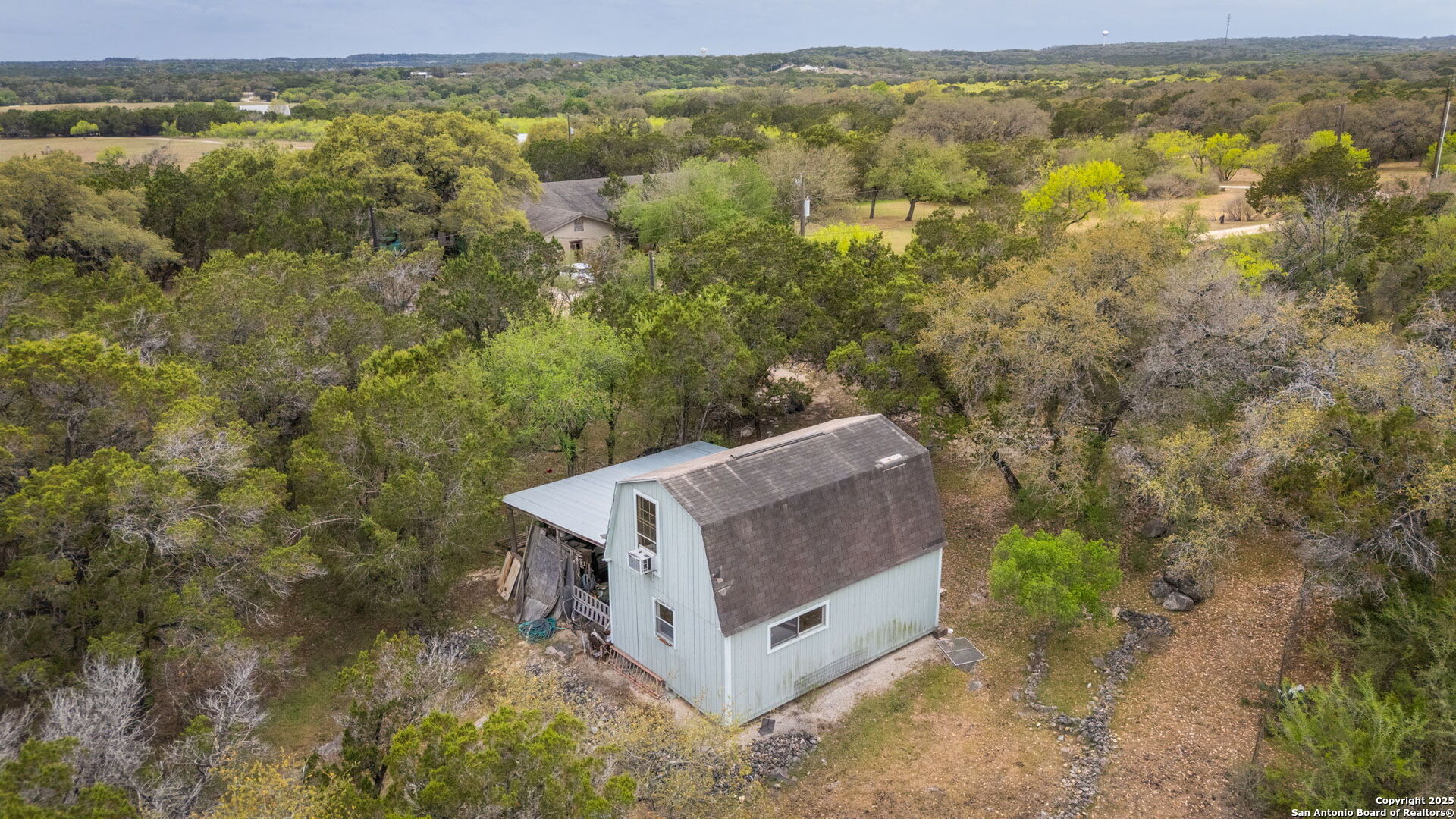 200 Elm Creek Road New Braunfels, TX 78132 - Photo 18 of 45 a view of a forest with a mountain in the background