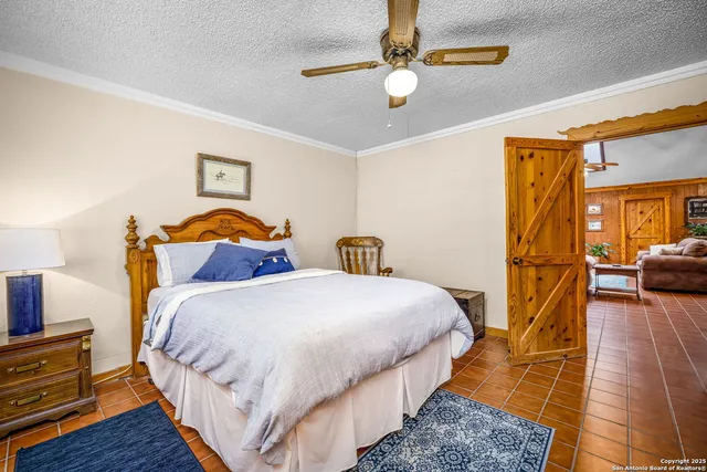 a bedroom with bed and wooden floor