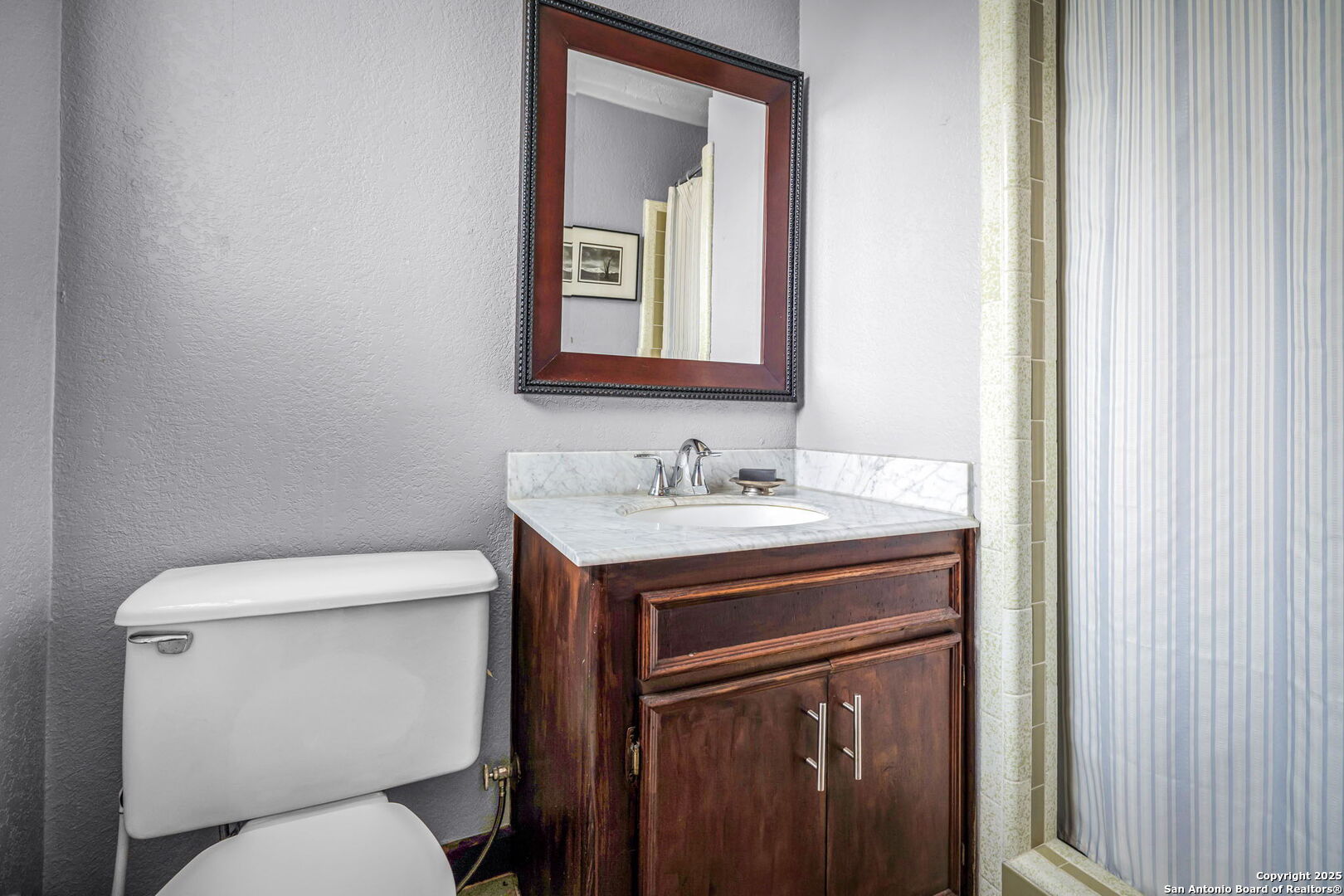 200 Elm Creek Road New Braunfels, TX 78132 - Photo 33 of 45 a bathroom with a toilet sink and mirror