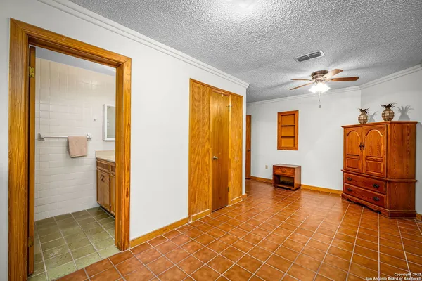 a view of a hallway with closet and a bathroom