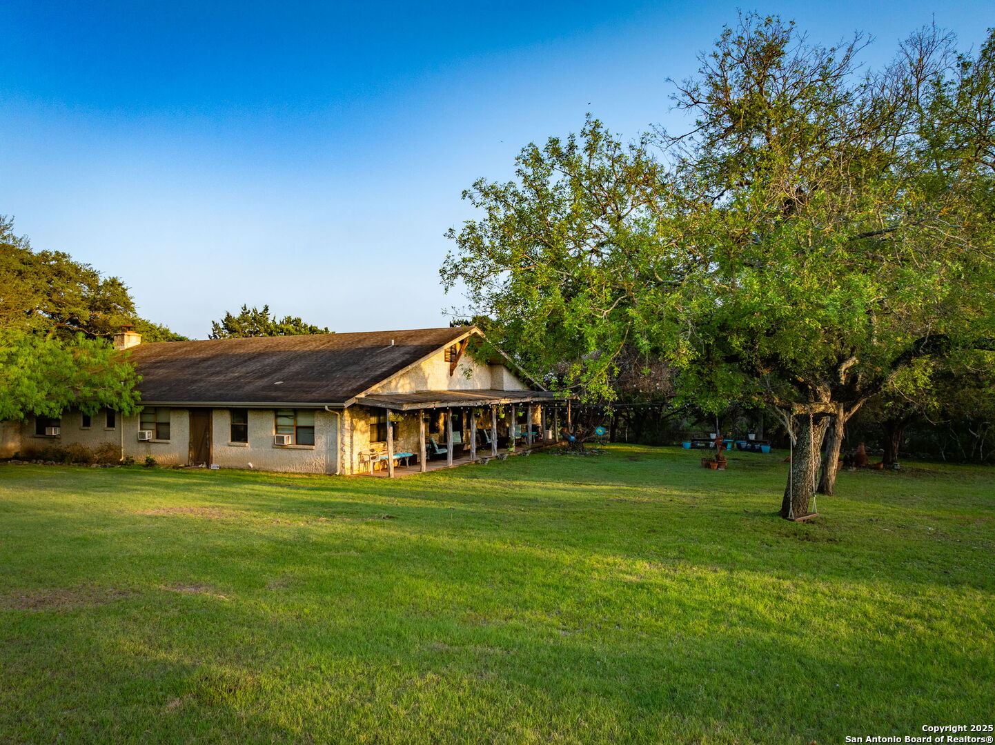 200 Elm Creek Road New Braunfels, TX 78132 - Photo 4 of 45 a front view of a house with a garden