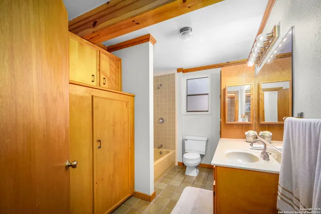 a bathroom with a sink a mirror and a shower