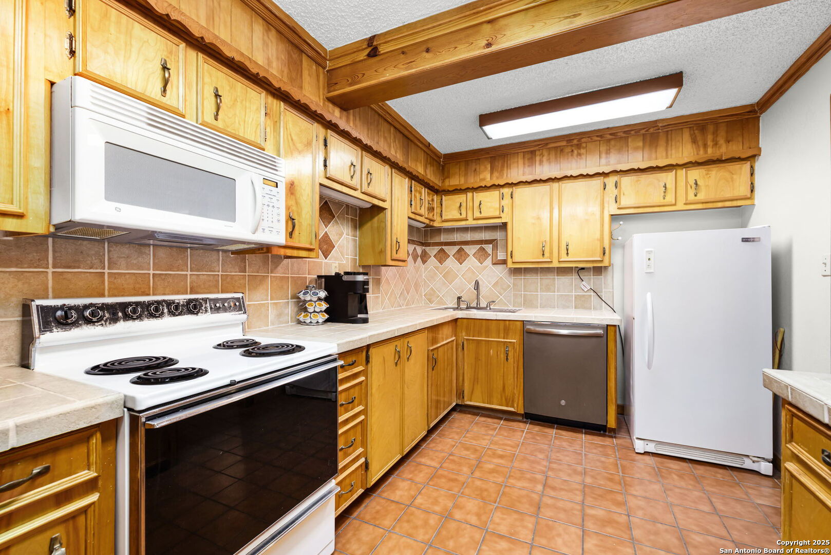 200 Elm Creek Road New Braunfels, TX 78132 - Photo 45 of 45 a kitchen with a sink a stove cabinets and a counter top space