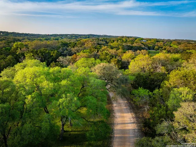 a view of an outdoor space with wooden floor and lake view
