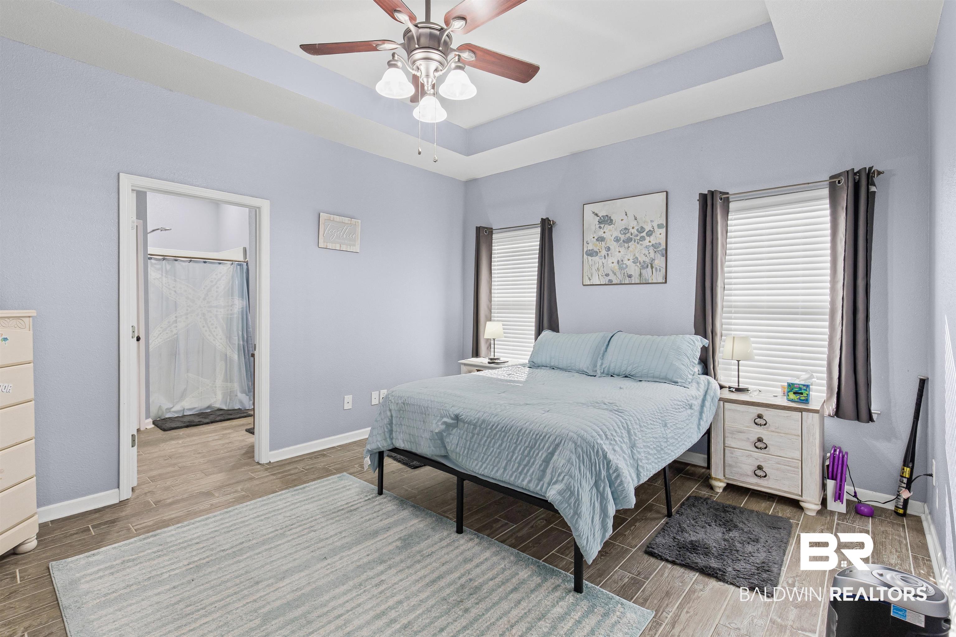 4107 Nottingham Drive Semmes, AL 36575 - Photo 9 of 23 Bedroom featuring wood tiled floors, a raised ceiling, ceiling fan, and multiple windows
