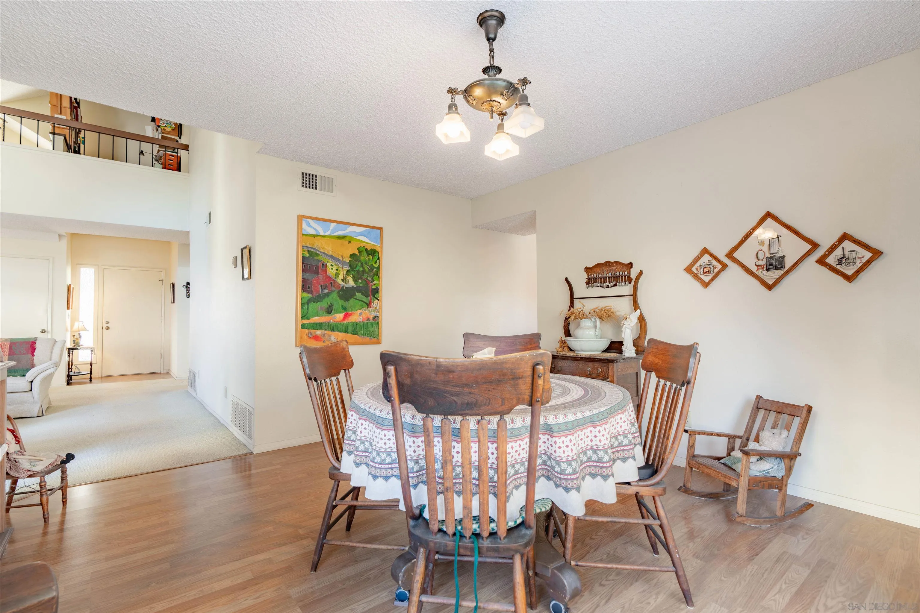 1440 Valleda Lane Encinitas, CA 92024 - Photo 13 of 54 a view of a dining room with furniture and wooden floor