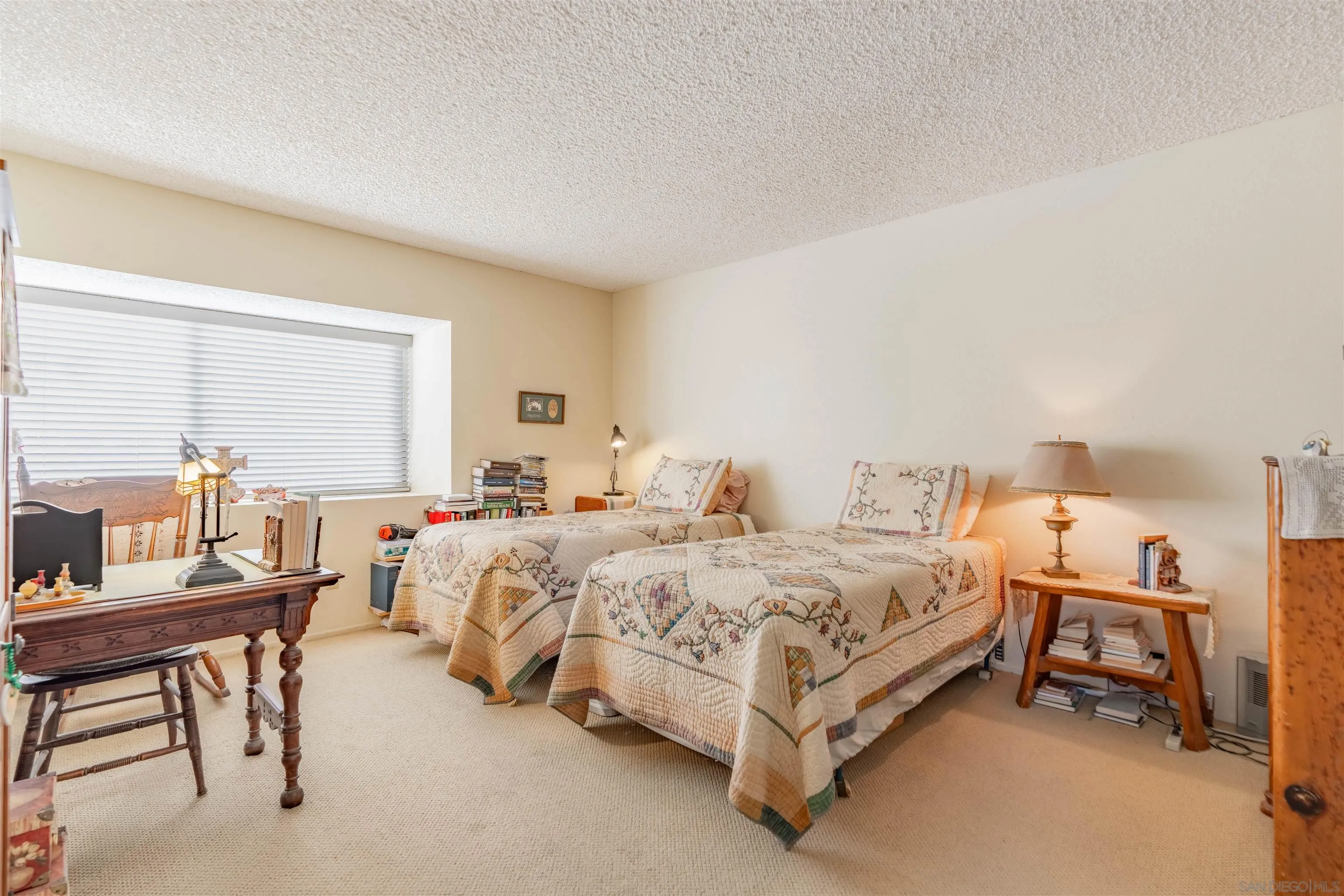1440 Valleda Lane Encinitas, CA 92024 - Photo 25 of 54 a spacious bedroom with two beds and a table