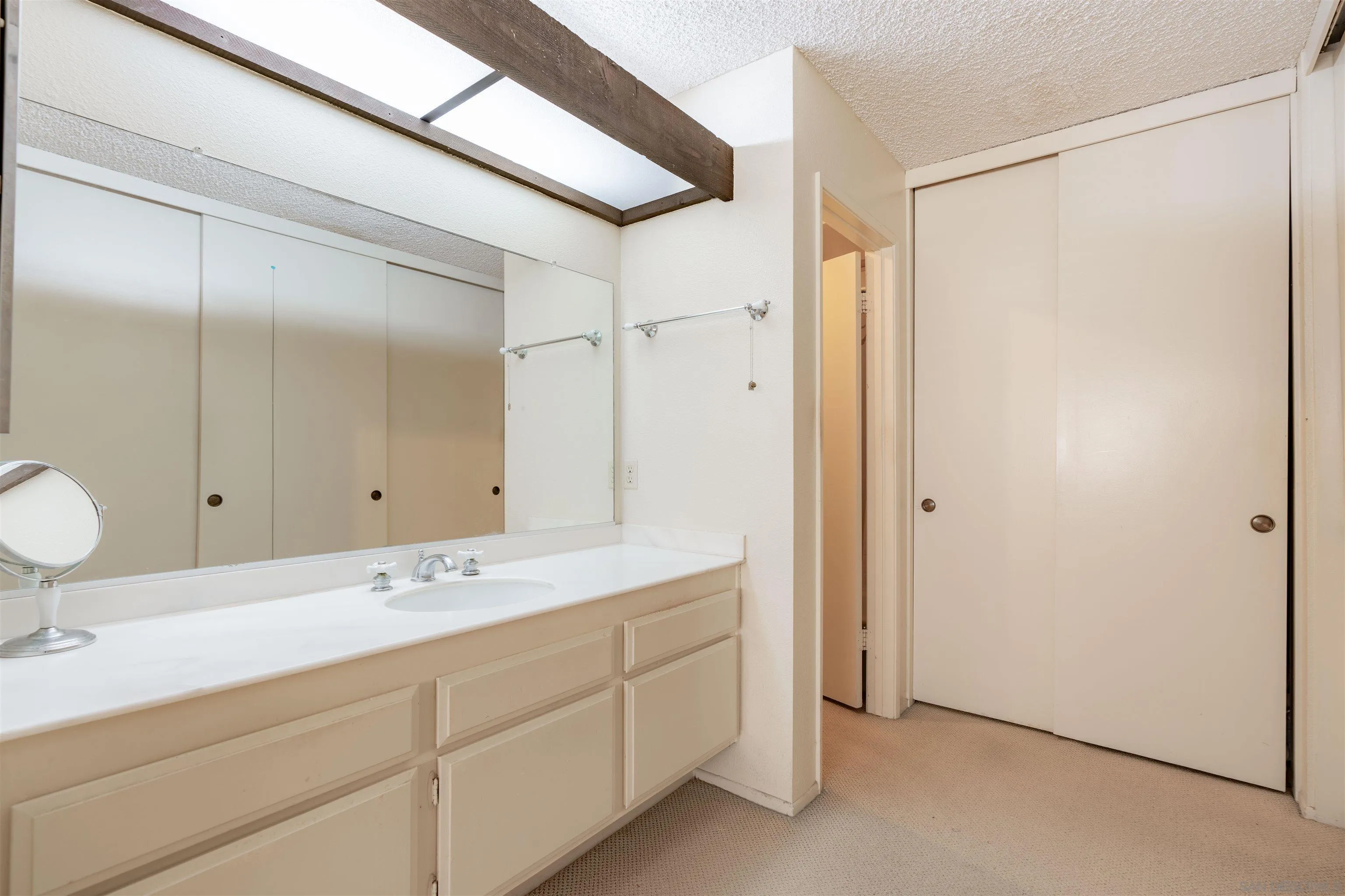 1440 Valleda Lane Encinitas, CA 92024 - Photo 26 of 54 a bathroom with a double vanity sink and mirror