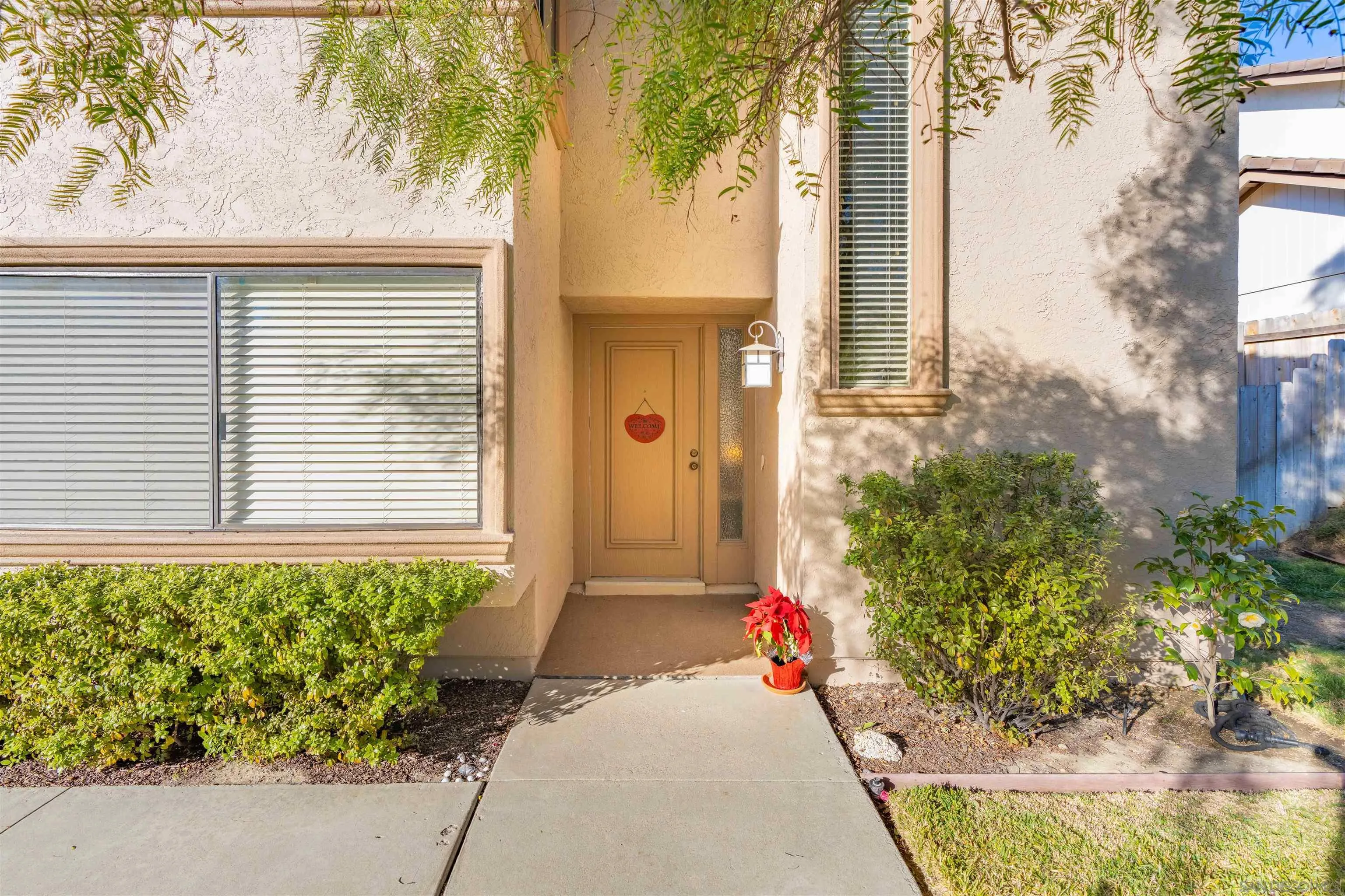 1440 Valleda Lane Encinitas, CA 92024 - Photo 3 of 54 a front view of a house with a yard and potted plants