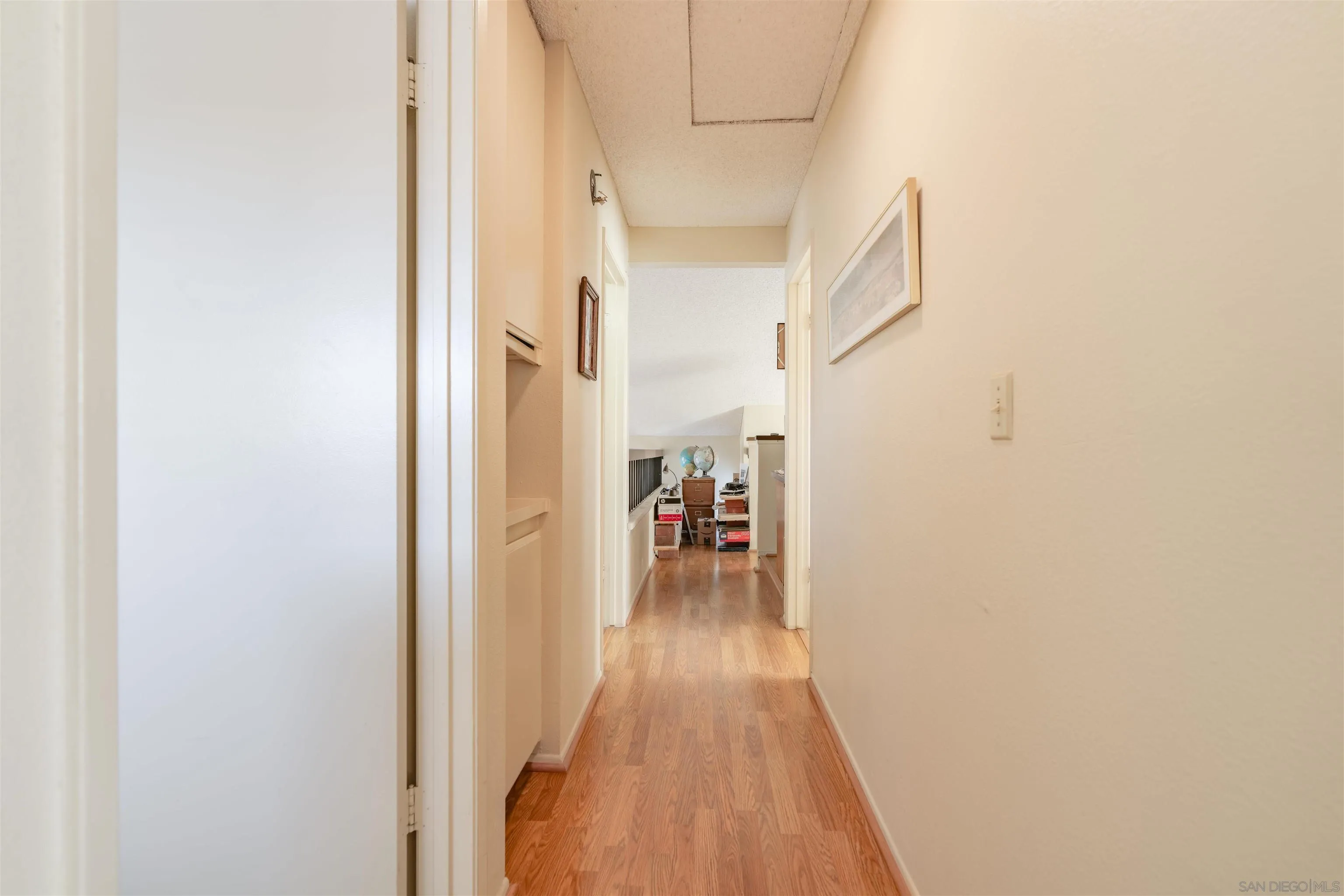 1440 Valleda Lane Encinitas, CA 92024 - Photo 32 of 54 a view of a hallway with wooden floor and a bathroom