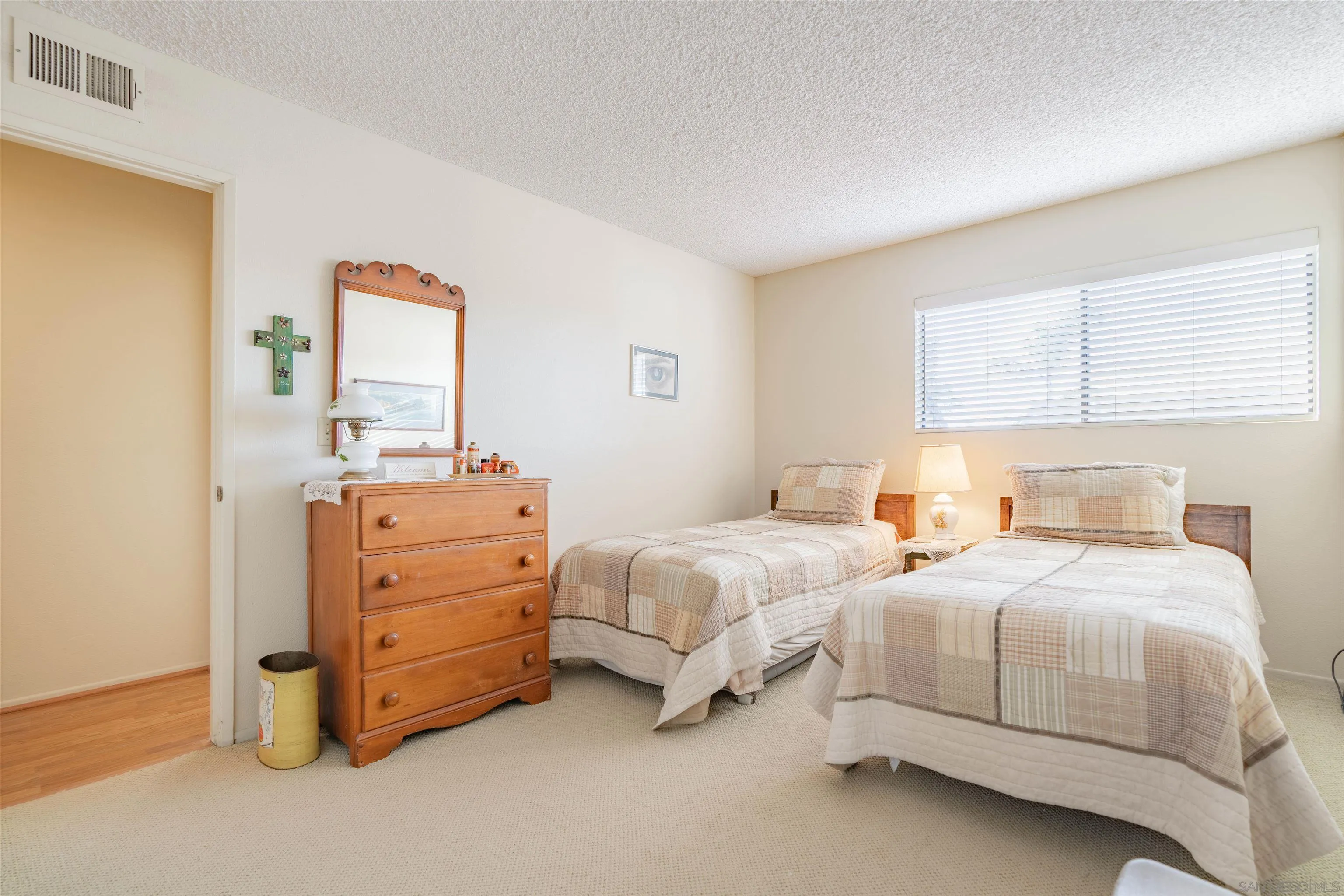 1440 Valleda Lane Encinitas, CA 92024 - Photo 34 of 54 a bedroom with two beds and painting on the wall