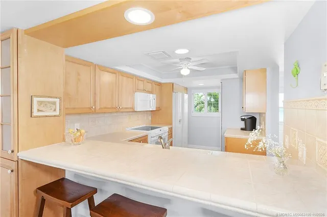 a kitchen with a refrigerator a sink and cabinets