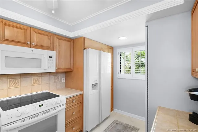 a living room with furniture chandelier and a large window