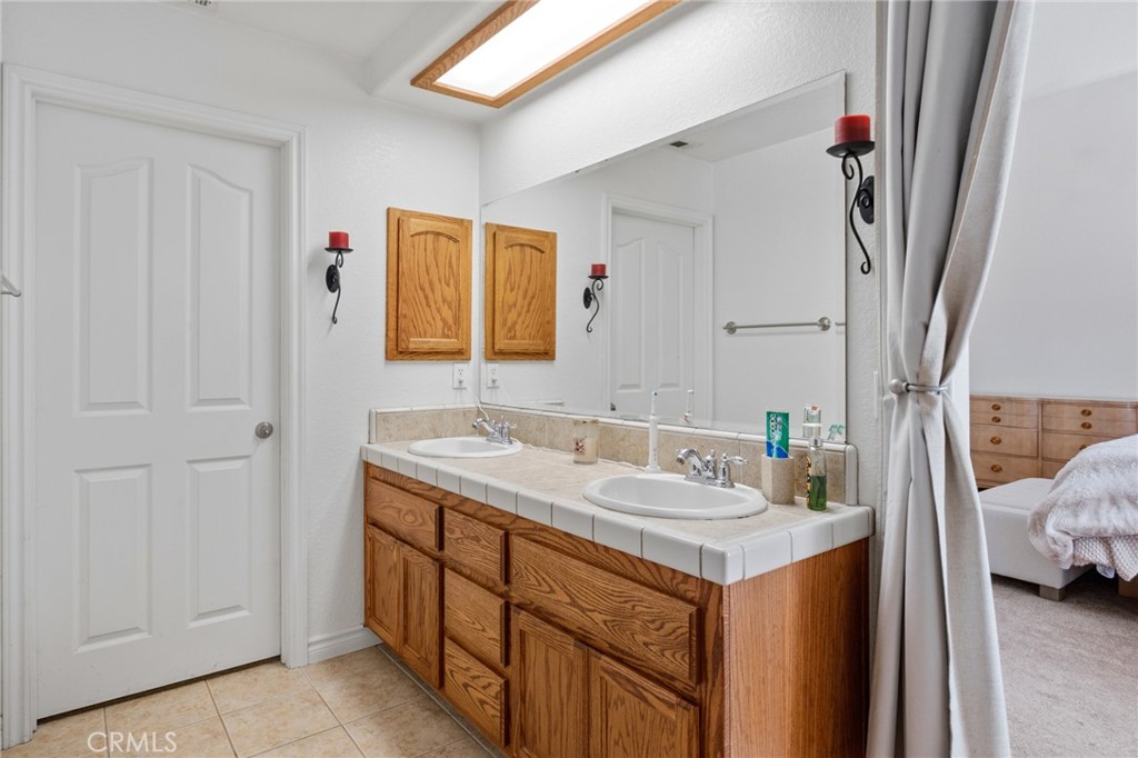 11025 El Esteban Road Phelan, CA 92371 - Photo 36 of 54 a bathroom with a sink and a mirror