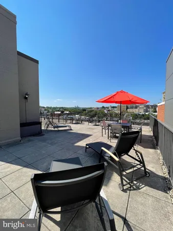 a view of a swimming pool with outdoor seating