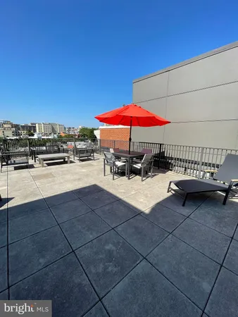 a view of a patio with a table and chairs under an umbrella