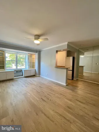 an empty room with a empty space and windows