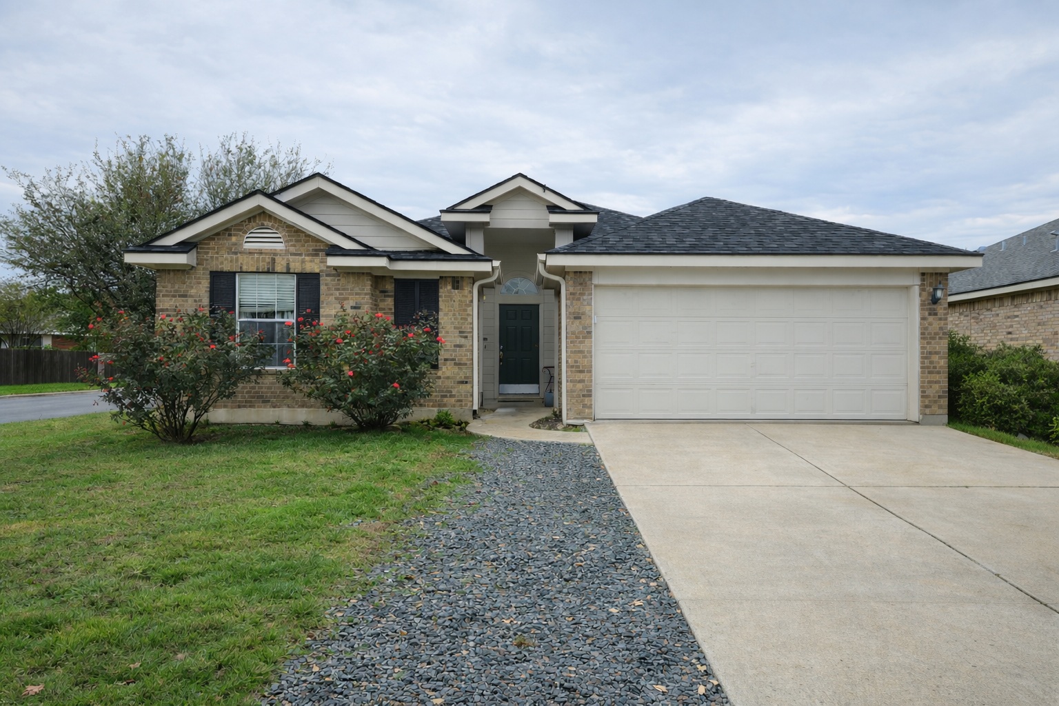 a front view of a house with garden