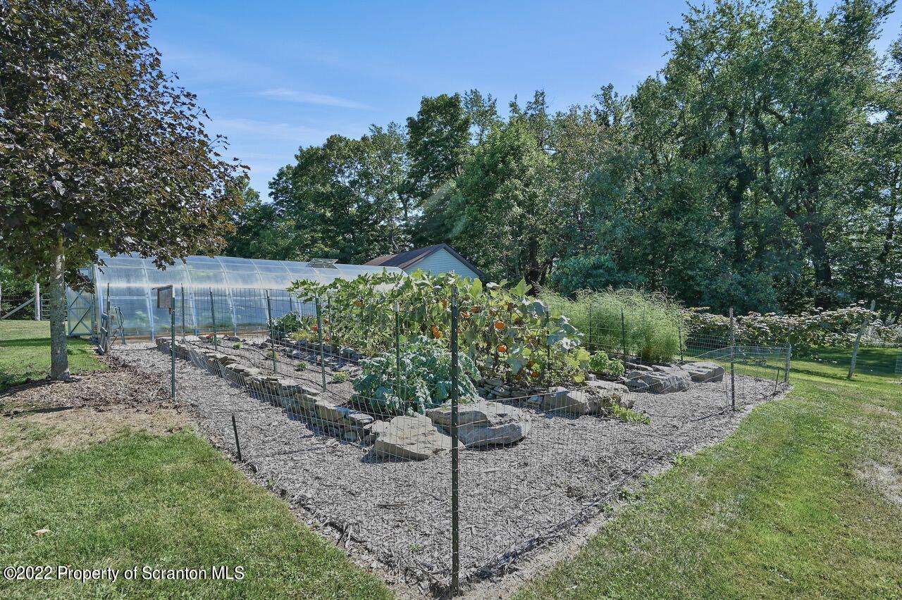 455 Spring Run Lane Moscow, PA 18444 - Photo 50 of 62 a backyard of a house with a garden