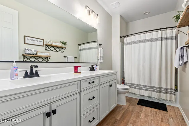 a bedroom with a bed and a night stand