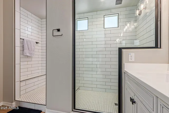 a bathroom with a double vanity sink and mirror