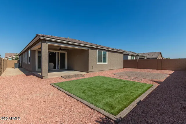 a backyard of a house with wooden fence