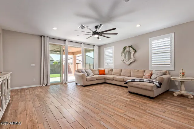 a view of a dining room with furniture a chandelier and wooden floor