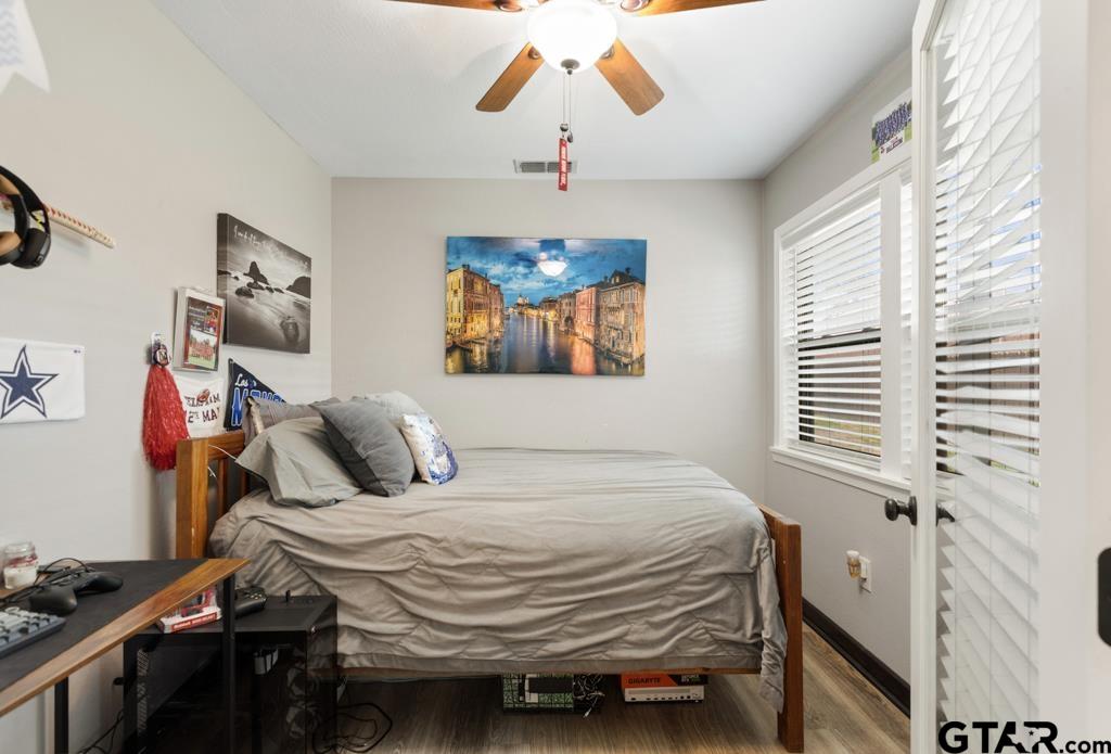 106 Ridgecrest Circle Bullard, TX 75757 - Photo 21 of 32 a bedroom with a bed and a chandelier